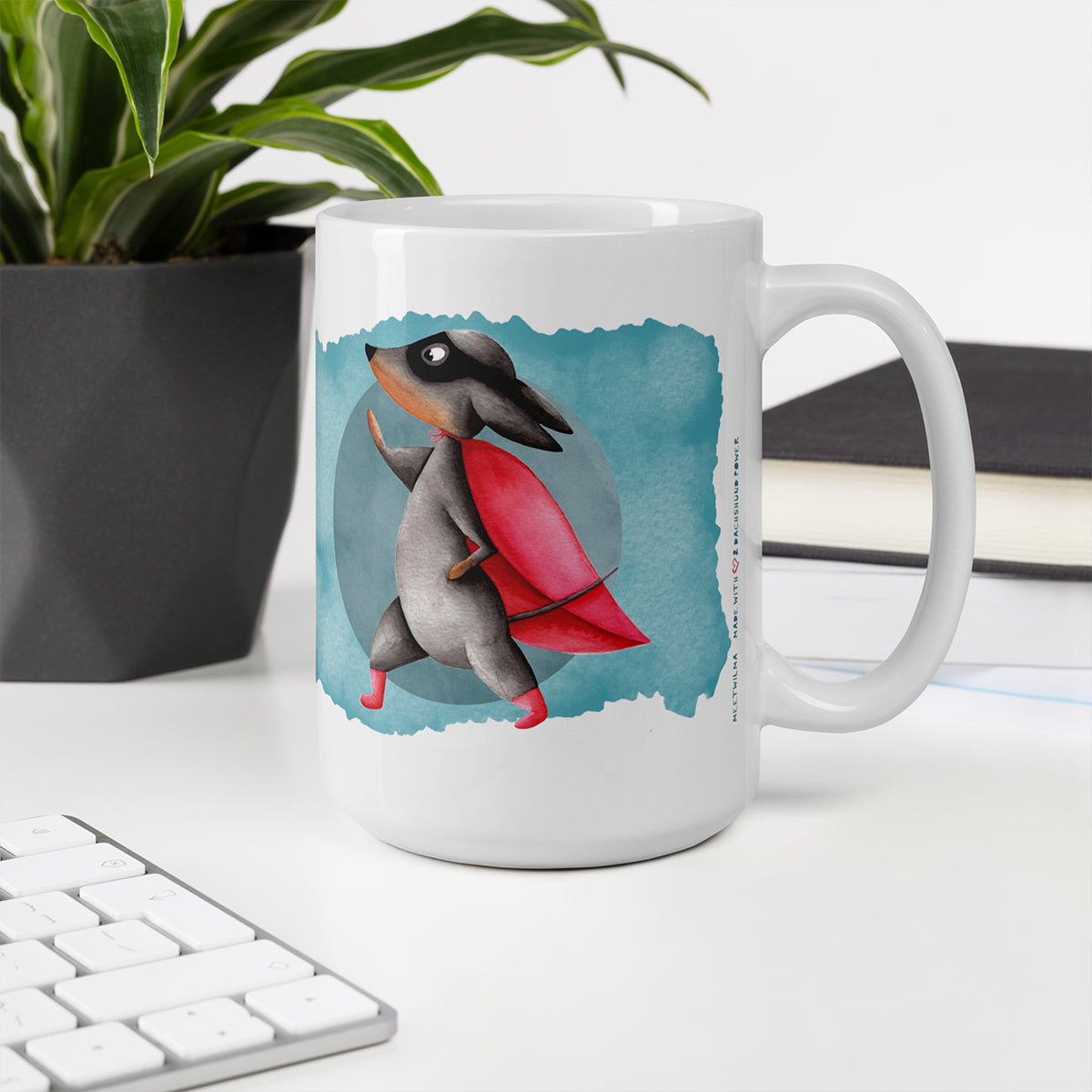 Picture of a desk with a Dachshund mug with an illustration of a dachshund wearing a cape watercolor Illustration print - 15oz