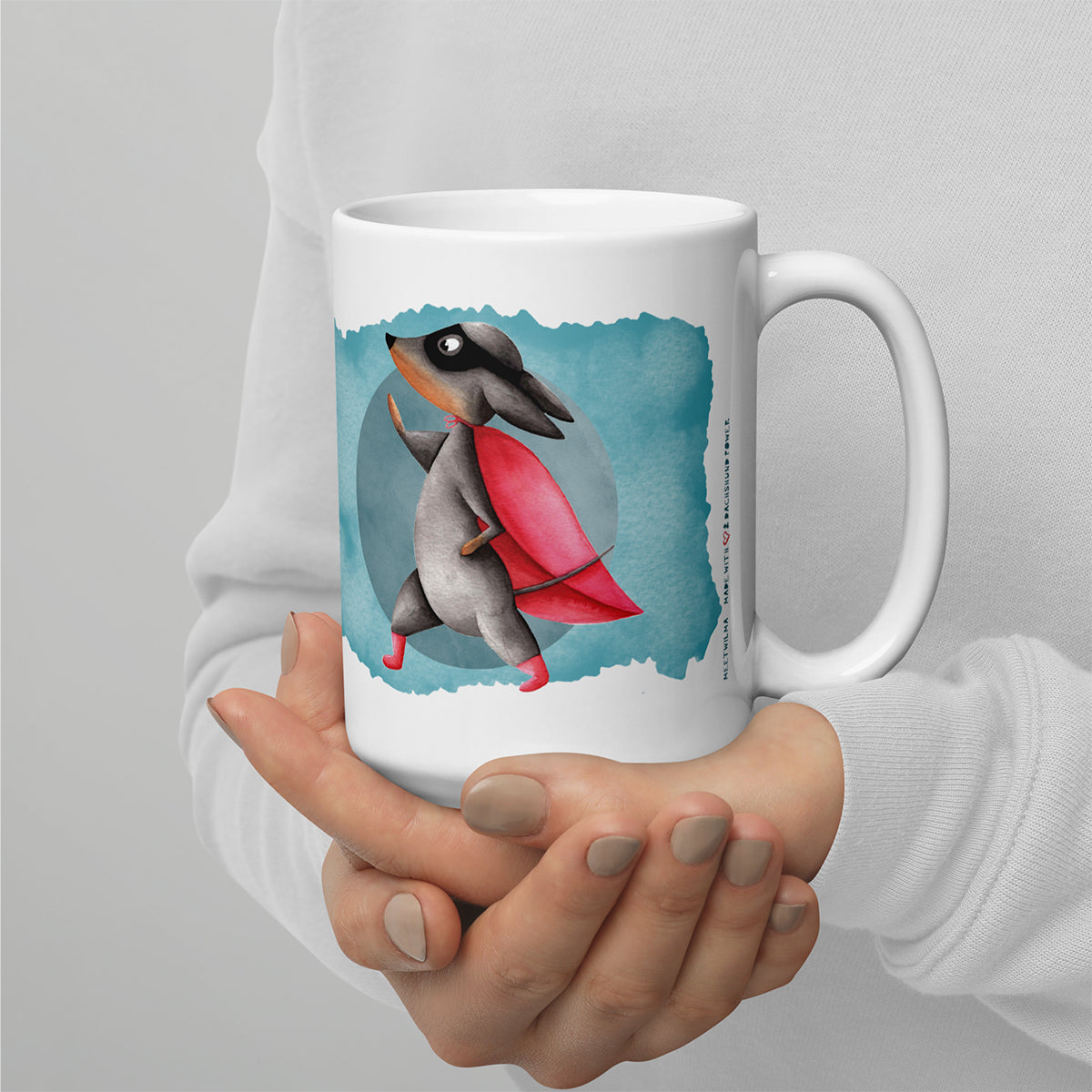 Picture of someone holding mug with a Dachshund wearing a cape watercolor Illustration print - 15oz